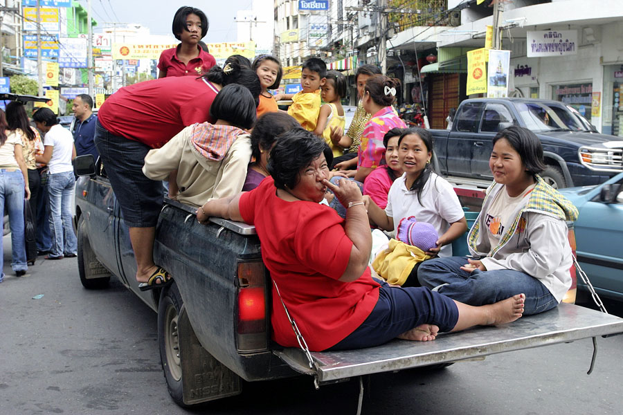 A classy Thai woman in the back of a pickup truck