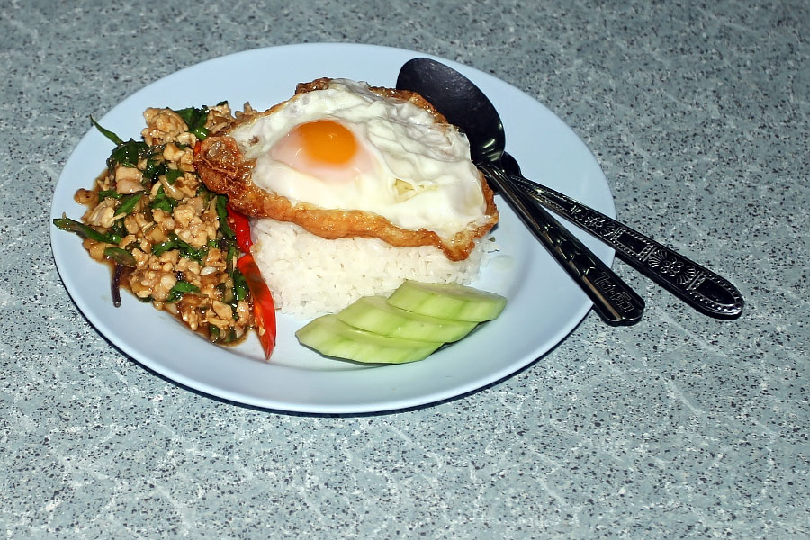 Put guh-prao gai (chicken with holy basil) and a fried egg on top