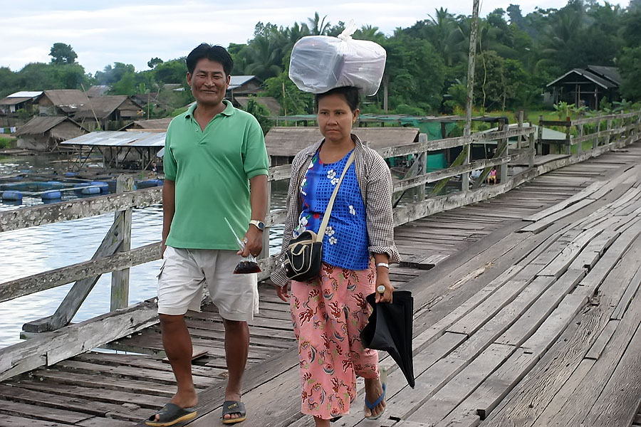 Local Mon people crossing the wooden footbridge in Sangkhlaburi
