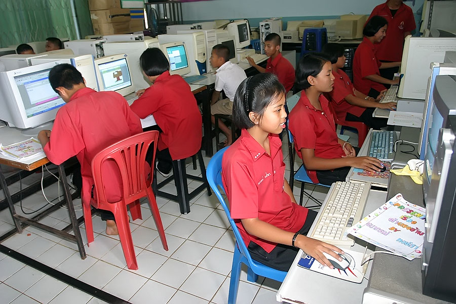 Mon children working with computers at school