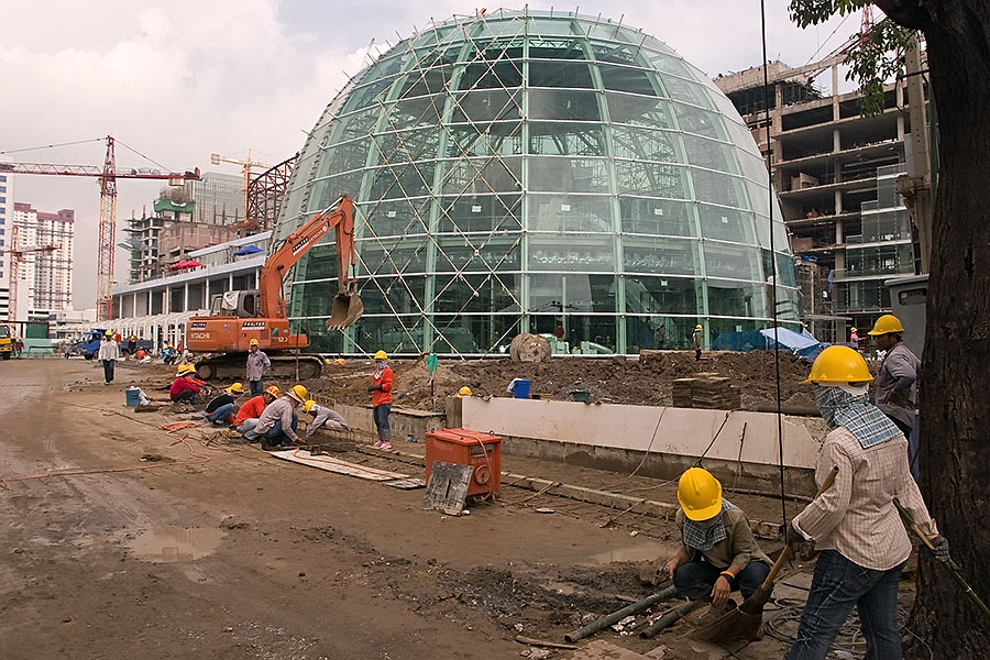 The construction of magnificent steel and glass buildings continues in Bangkok but the slums and shanties remain