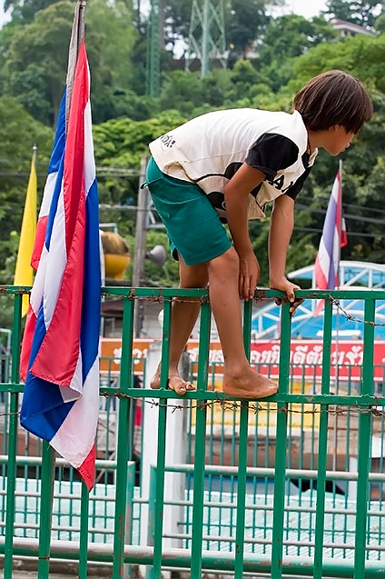 Burmese kid climbing over the border to Thailand at Mae Sai, Chiang Rai