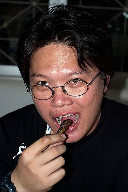 Munching into a juicy, deep-fried grasshopper