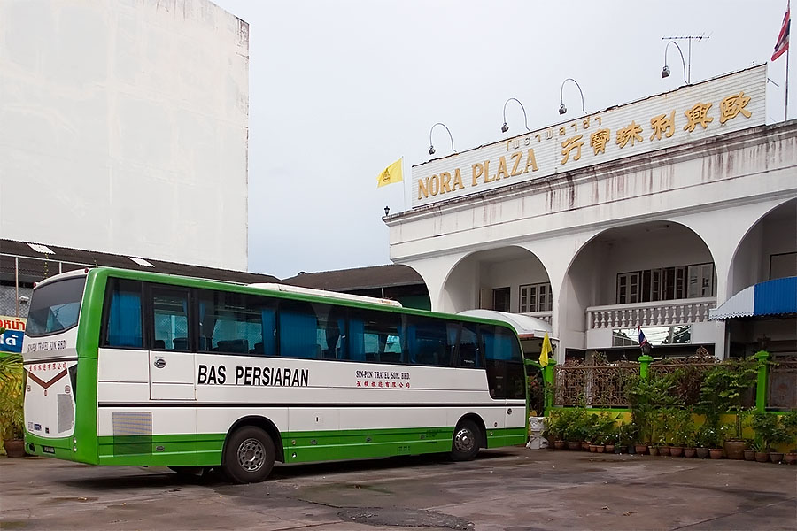 Malaysian tour bus outside Nora Plaza