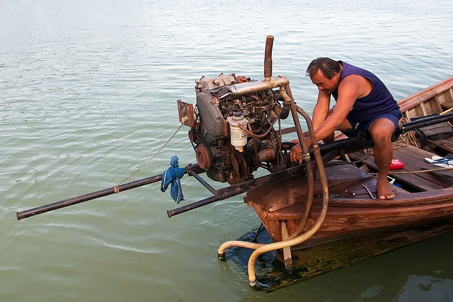 Longtail boat engine maintenance at Patong beach