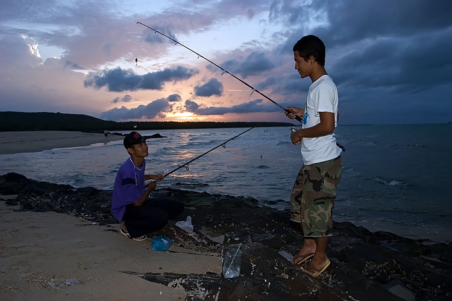 Muslim boys fishing at Samila Beach, Songkhla