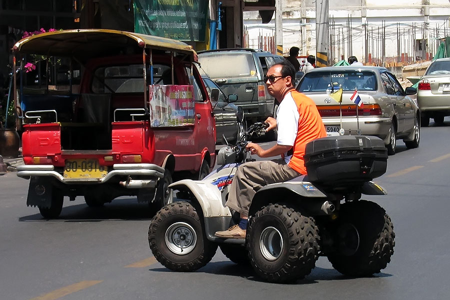 Quad bike being driven on the road in Thailand