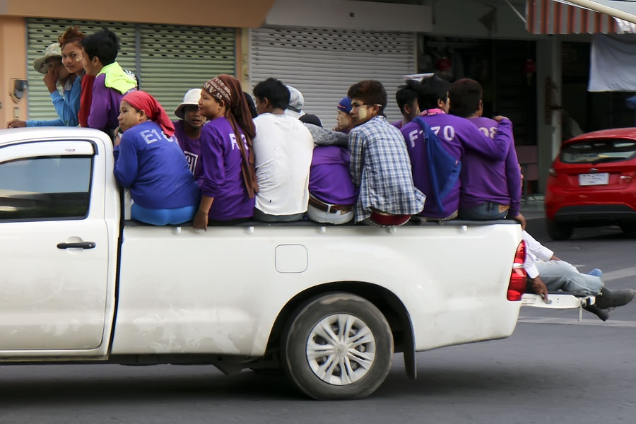 Burmese workers on pickup truck