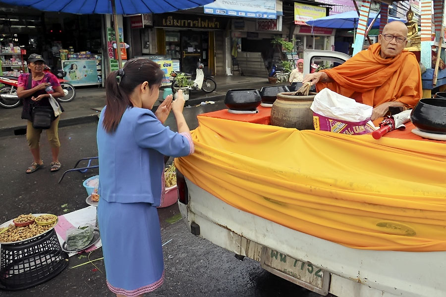 Woman receiving lustral water blessing