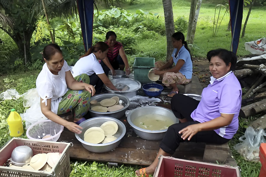 The women prepare food and wash dishes