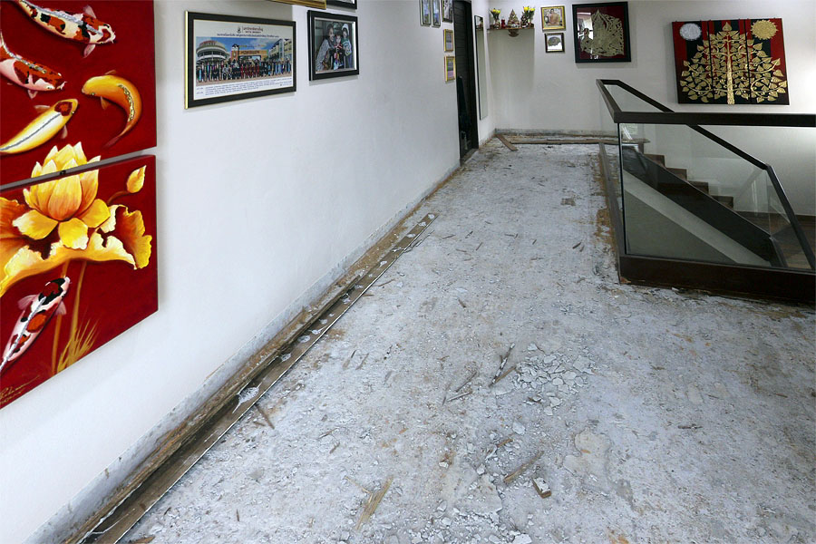 The brown dust is evidence of termite damage along the bottom of the walls