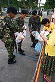 Giving soldiers food - scene from Bangkok in 2006 - Click for larger image