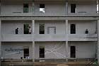 The construction workers live temporarily in the partially completed buildings they are working on - Click for larger image