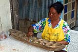 Thai lady playing the traditional game of maa-gep - Click for larger image