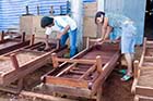 Thais and Burmese varnishing sunbeds in Khaolak - Click for larger image