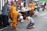 Giving Alms to Monks at Gim Yong Market - Click for larger image